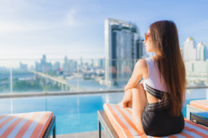 portrait beautiful young asian woman relaxes leisure around swimming pool