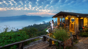 woman taking photo morning mist phu lang ka phayao thailand